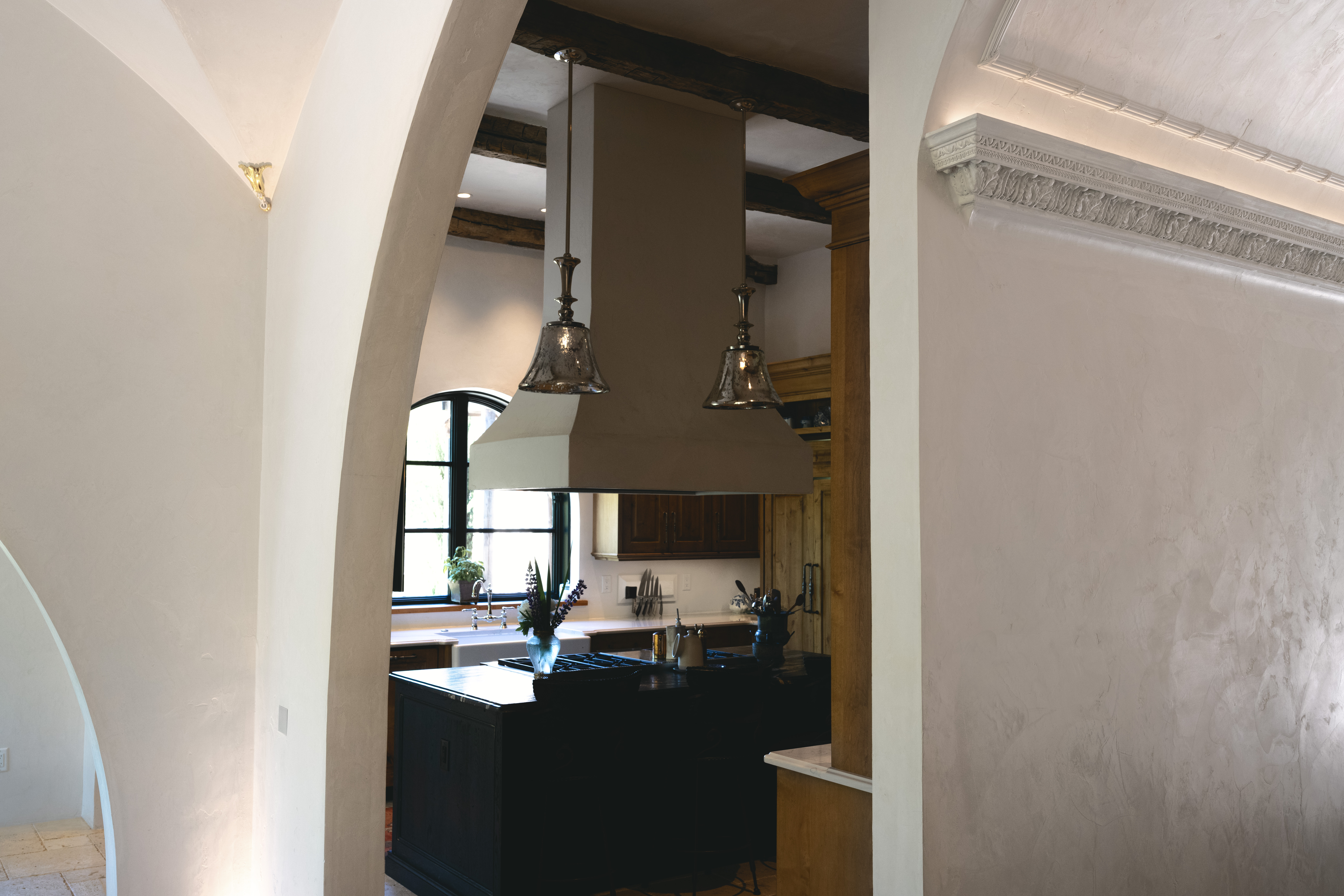 Run cornice meeting a hardcoat plaster wall in raking morning light, hospitality residence great room